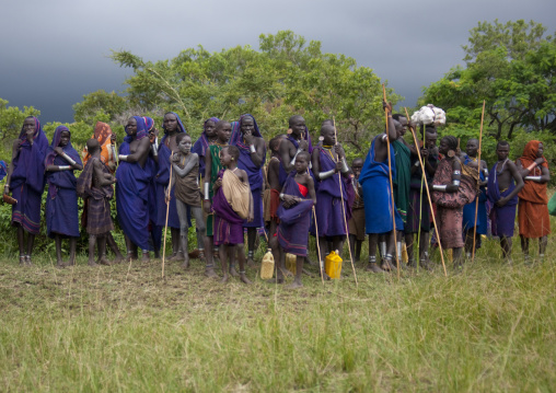 Surma women and children watching a dong stick fighting session, Tulgit, Omo valley, Ethiopia