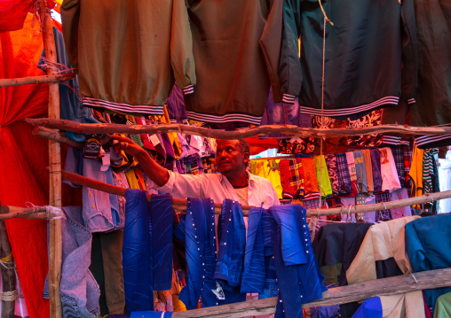 Ethiopian man selling clothes in the market, Harari region, Harar, Ethiopia