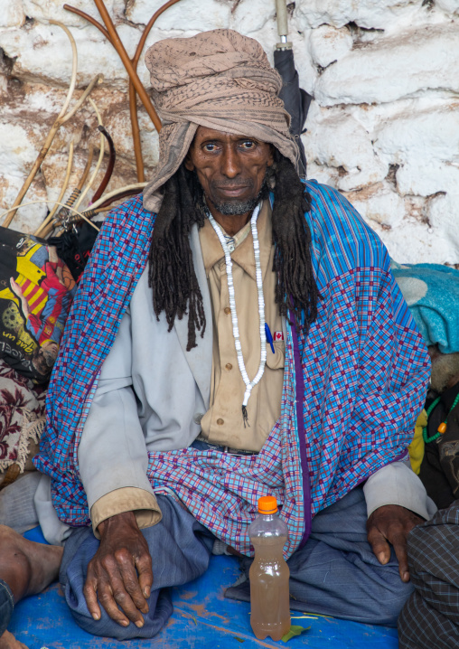 Oromo pilgrim man with a holy water bottle in Sheikh Hussein shrine, Oromia, Sheik Hussein, Ethiopia