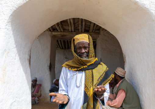 Oromo pilgrim man with his shoes in the hands in Sheikh Hussein shrine, Oromia, Sheik Hussein, Ethiopia