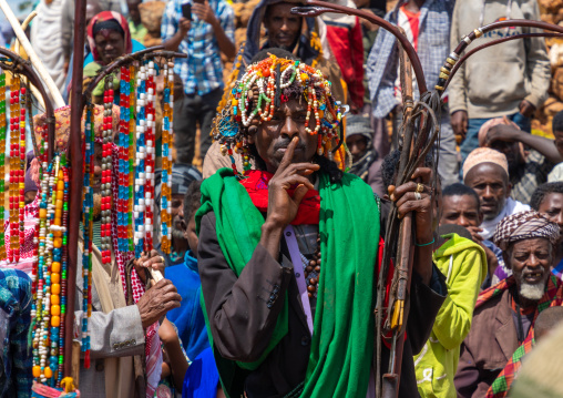 Sufi leader in front of a oulle forked stick decorated with necklaces and prayerbeads, Oromia, Sheik Hussein, Ethiopia
