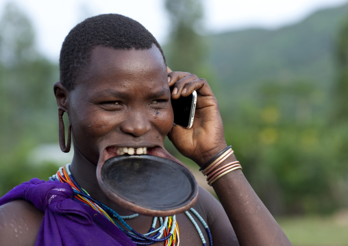 Suri Woman With Lip Plate And Mobile Phone, Turgit Village, Omo Valley, Ethiopia