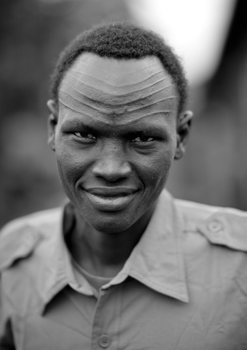 Policemean from the nuer tribe with decorative scarifications on the forehead, Gambella province, Ethiopia