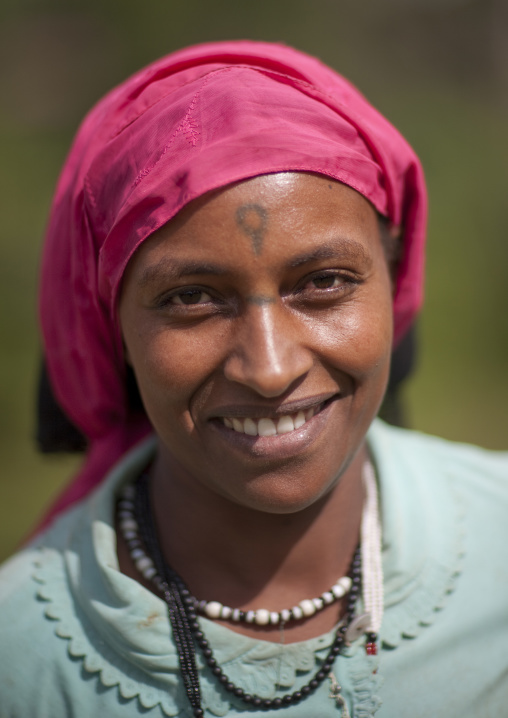 Veiled amahra woman with a tatto on the forehead, Ethiopia