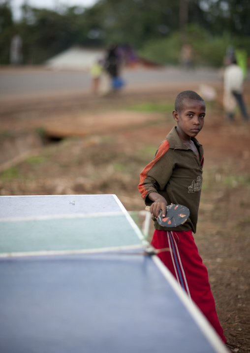 Boy playing ping pong in the village of kumbi, Ethiopia