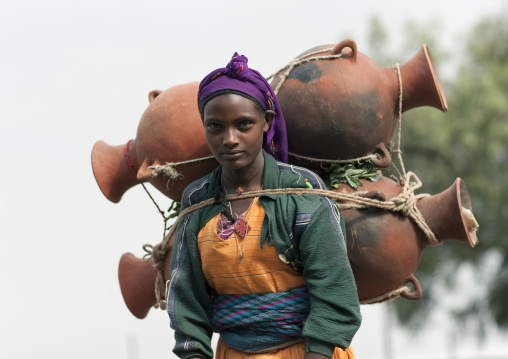 Oromo Woman Carrying Jars On Her Back, Tulugulu Village, Ethiopia