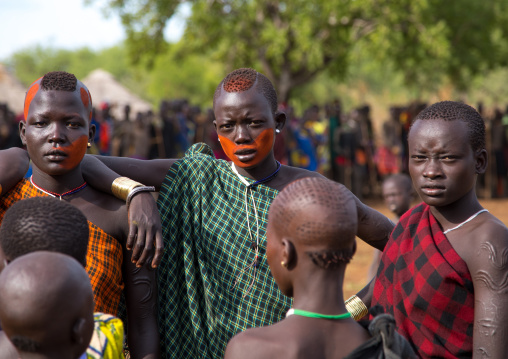 Teenage girls with makeup on the face during the fat men ceremony in Bodi tribe, Omo valley, Hana Mursi, Ethiopia