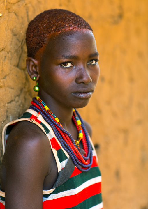 Portrait of ayoung woman from Hamer tribe with short hair, Omo valley, Turmi, Ethiopia