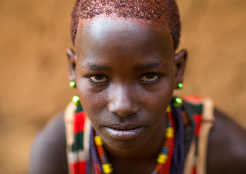 Portrait of ayoung woman from Hamer tribe with short hair, Omo valley, Turmi, Ethiopia