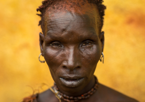 Portrait of a Hamer tribe woman with red ochre on the face, Omo valley, Turmi, Ethiopia
