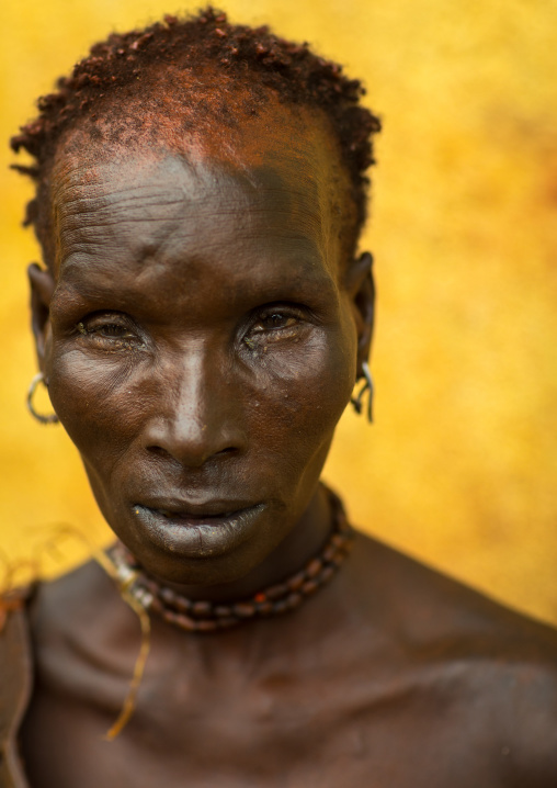 Portrait of a Hamer tribe woman with red ochre on the face, Omo valley, Turmi, Ethiopia