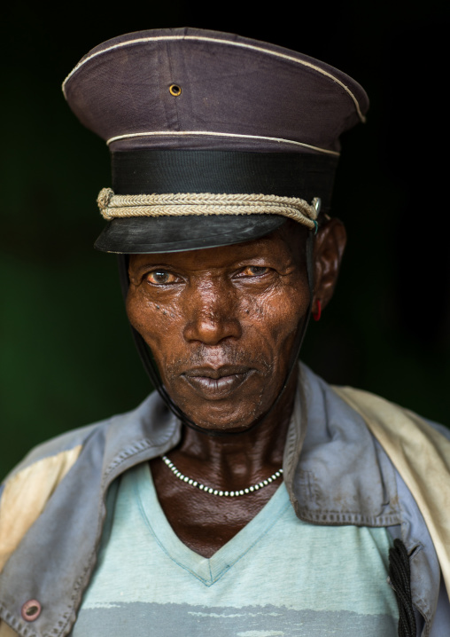 Portrait of a Hamer tribe man with an old police cap, Omo valley, Turmi, Ethiopia