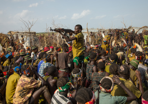 Man shooting with a kalashnikov during the proud ox ceremony in the Dassanech tribe, Turkana County, Omorate, Ethiopia