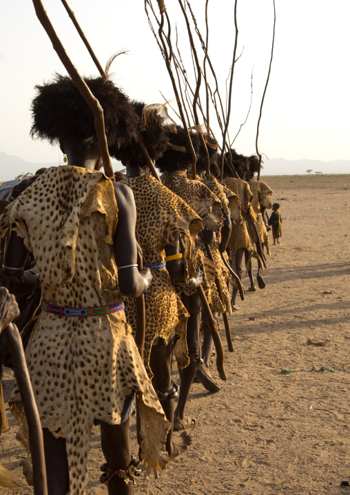 Dassanech men with leopard skins and ostrich feathers wigs during Dimi ceremony to celebrate circumcision of teenagers, Turkana County, Omorate, Kenya