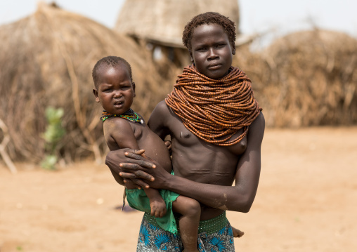 Portrait of a Nyangatom tribe mother with her child wearing some huge necklaces, Omo Valley, Kangate, Ethiopia