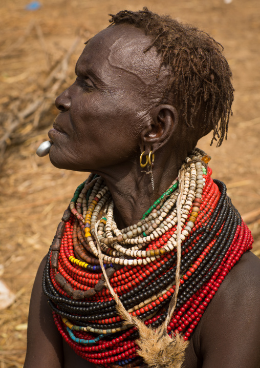 Portrait of an old Nyangatom tribe woman in a village with a chin decoration, Omo Valley, Kangate, Ethiopia