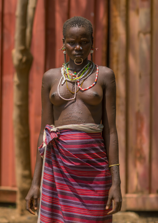 Portrait of a sudanese Toposa tribe woman refugee with scarifications on her body, Omo Valley, Kangate, Ethiopia
