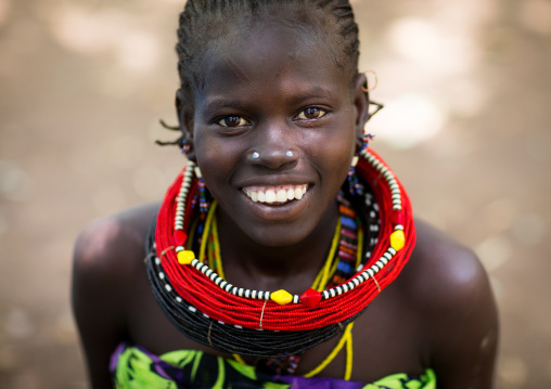 Portrait of a smiling sudanese Toposa tribe girl refugee, Omo Valley, Kangate, Ethiopia