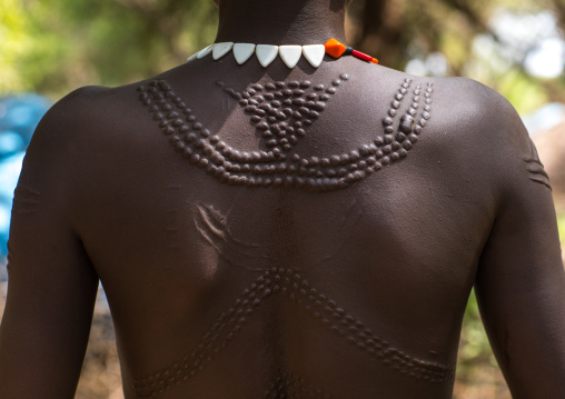 Sudanese Toposa tribe woman refugee with scarifications on her body, Omo Valley, Kangate, Ethiopia
