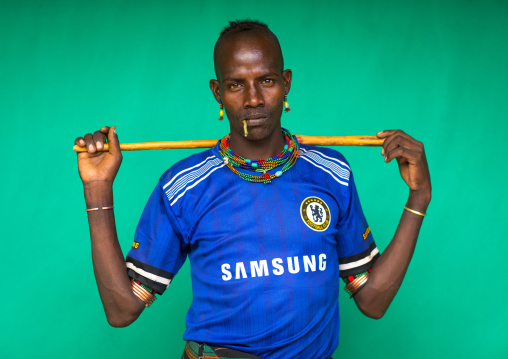 Portrait of a Hamer tribe man wearing a chelsea football shirt, Omo valley, Dimeka, Ethiopia