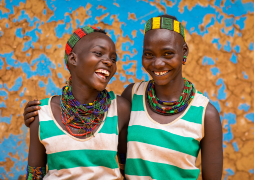 Hamer tribe young women laughing, Omo valley, Dimeka, Ethiopia