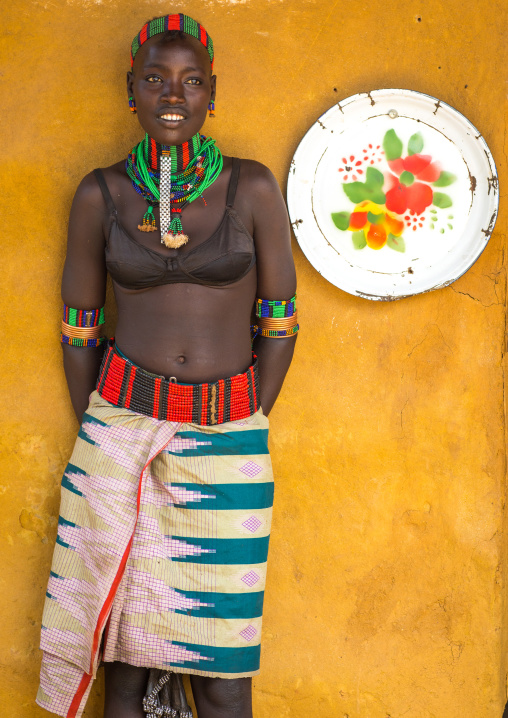 Hamer tribe woman standing at the entrance of a restaurant, Omo valley, Dimeka, Ethiopia