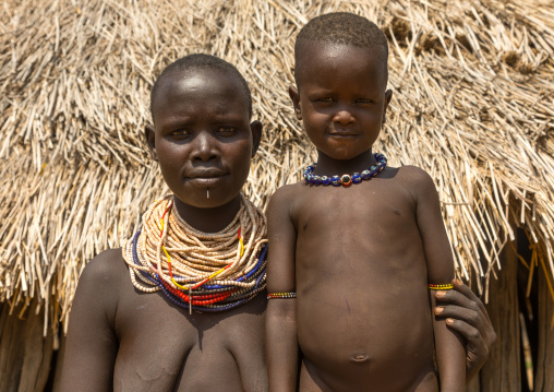 Karo tribe mother with her son called Lale who was born mingi but was saved after the tradition of killing them ended in the village, Omo valley, Korcho, Ethiopia