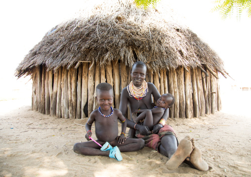 Karo tribe mother with her children who were born mingi but were saved after the tradition of killing them ended in the village, Omo valley, Korcho, Ethiopia