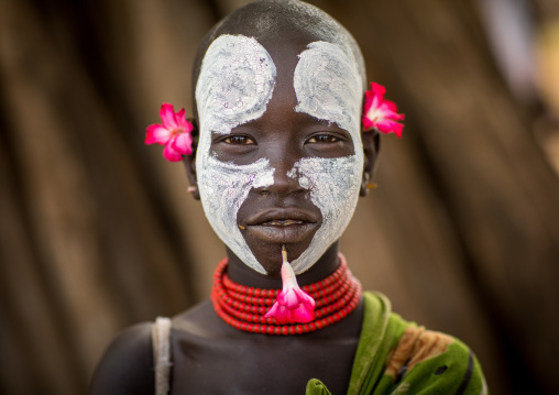Portrait of a Karo tribe child with flowers decorations, Omo valley, Korcho, Ethiopia