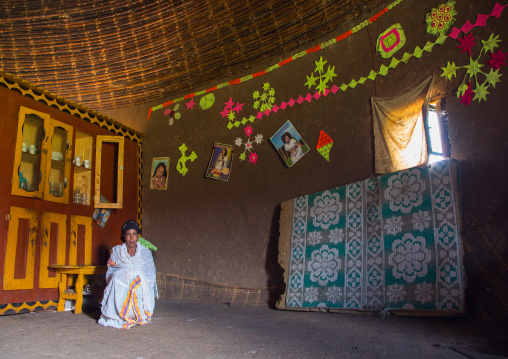 Gurage woman inside her traditional house decorated with doilies on the walls, Gurage Zone, Butajira, Ethiopia