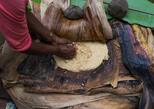 A Dorze woman prepares unleavened bread made from the false banana tree, Gamo Gofa Zone, Gamole, Ethiopia