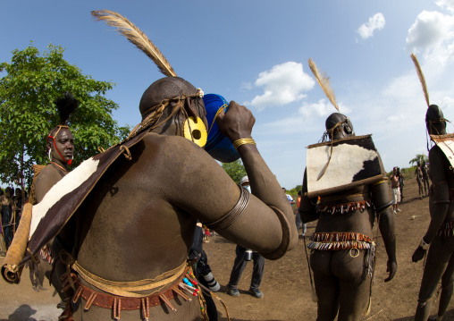 Bodi tribe fat men drinking milk during the Kael ceremony, Omo valley, Hana Mursi, Ethiopia