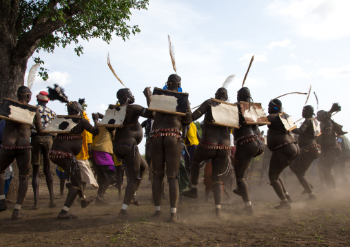 Bodi tribe fat men dancing in the dust during Kael ceremony, Omo valley, Hana Mursi, Ethiopia