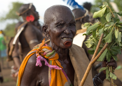 Old woman with a chin labret during the fat men ceremony in Bodi tribe, Omo valley, Hana Mursi, Ethiopia