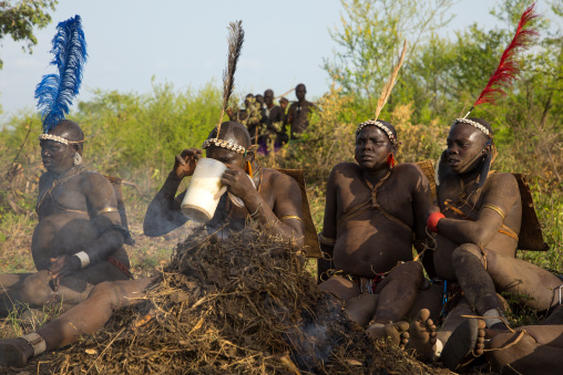 Bodi tribe fat men resting during Kael ceremony, Omo valley, Hana Mursi, Ethiopia