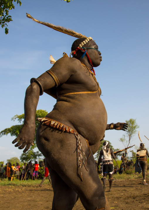 Bodi tribe fat man running during Kael ceremony, Omo valley, Hana Mursi, Ethiopia