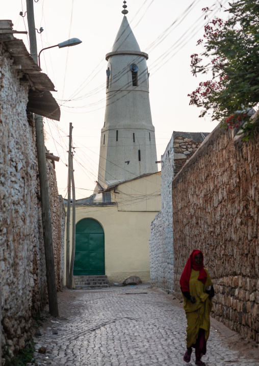 Harari woman passing in front of a mosque, Harari Region, Harar, Ethiopia