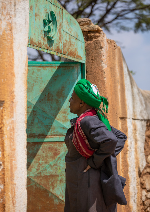Harari cleric in front of an islamic gateway, Harari Region, Harar, Ethiopia