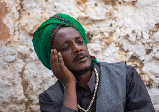 Harari islamic cleric with closed eyes praying during a sufi celebration, Harari Region, Harar, Ethiopia