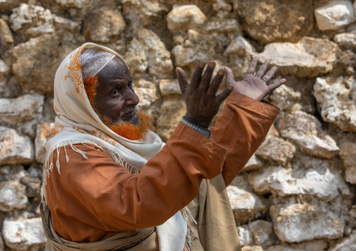 Harari man with a red beard praying during a sufi celebration, Harari Region, Harar, Ethiopia