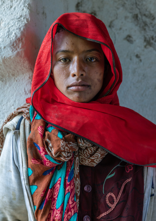 Veiled harari young woman in red, Harari Region, Harar, Ethiopia