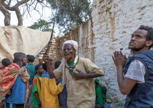 Harari man dancing with a huge knife during a sufi celebration, Harari Region, Harar, Ethiopia