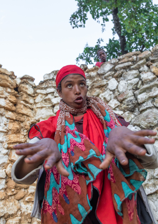 Sufi woman with a red veil into trance during a muslim ceremony, Harari Region, Harar, Ethiopia