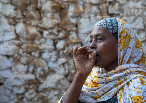 Veiled harari woman making ululation during a muslim ceremony, Harari Region, Harar, Ethiopia