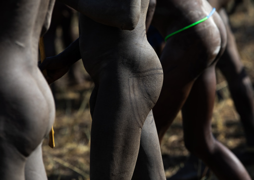 Naked suri tribe warriors make-up during a donga stick fighting ritual, Omo valley, Kibish, Ethiopia