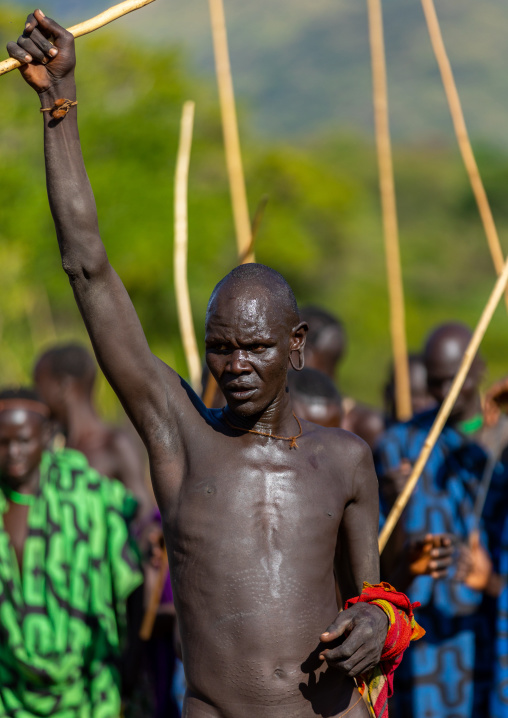 Suri tribe warrior parading during a donga stick fighting ritual, Omo valley, Kibish, Ethiopia