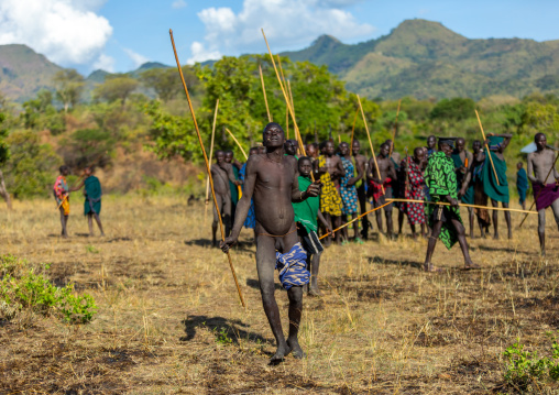 Suri tribe warrior dancing during a donga stick fighting ritual, Omo valley, Kibish, Ethiopia