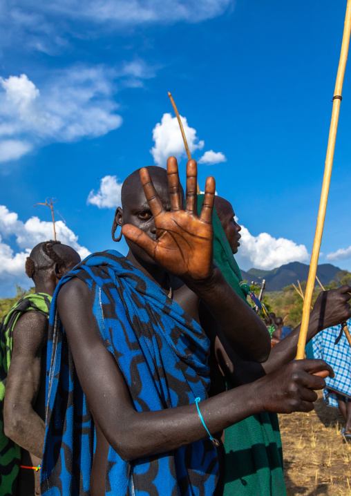 Suri tribe warrior refusing a photography during a donga stick fighting ritual, Omo valley, Kibish, Ethiopia