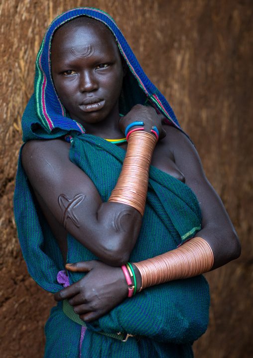 Portrait of a suri tribe woman with impressive bracelets, Omo valley, Kibish, Ethiopia