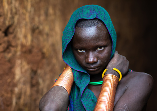 Portrait of a suri tribe young woman with impressive bracelets, Omo valley, Kibish, Ethiopia